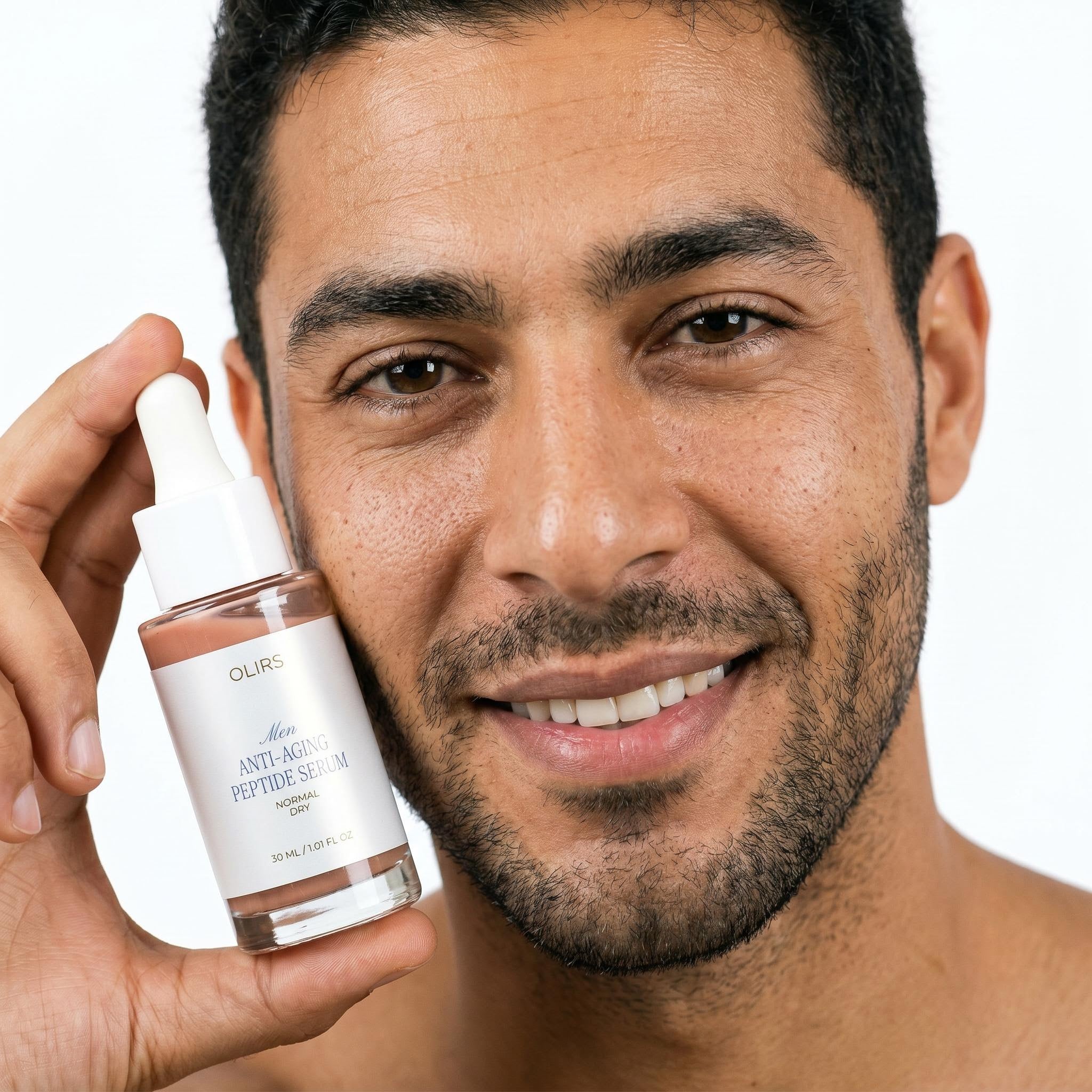 Skin Renewal Trio - man showing OLIRS Anti-Aging Peptide Serum in 30 ml bottle for smoother-looking skin.