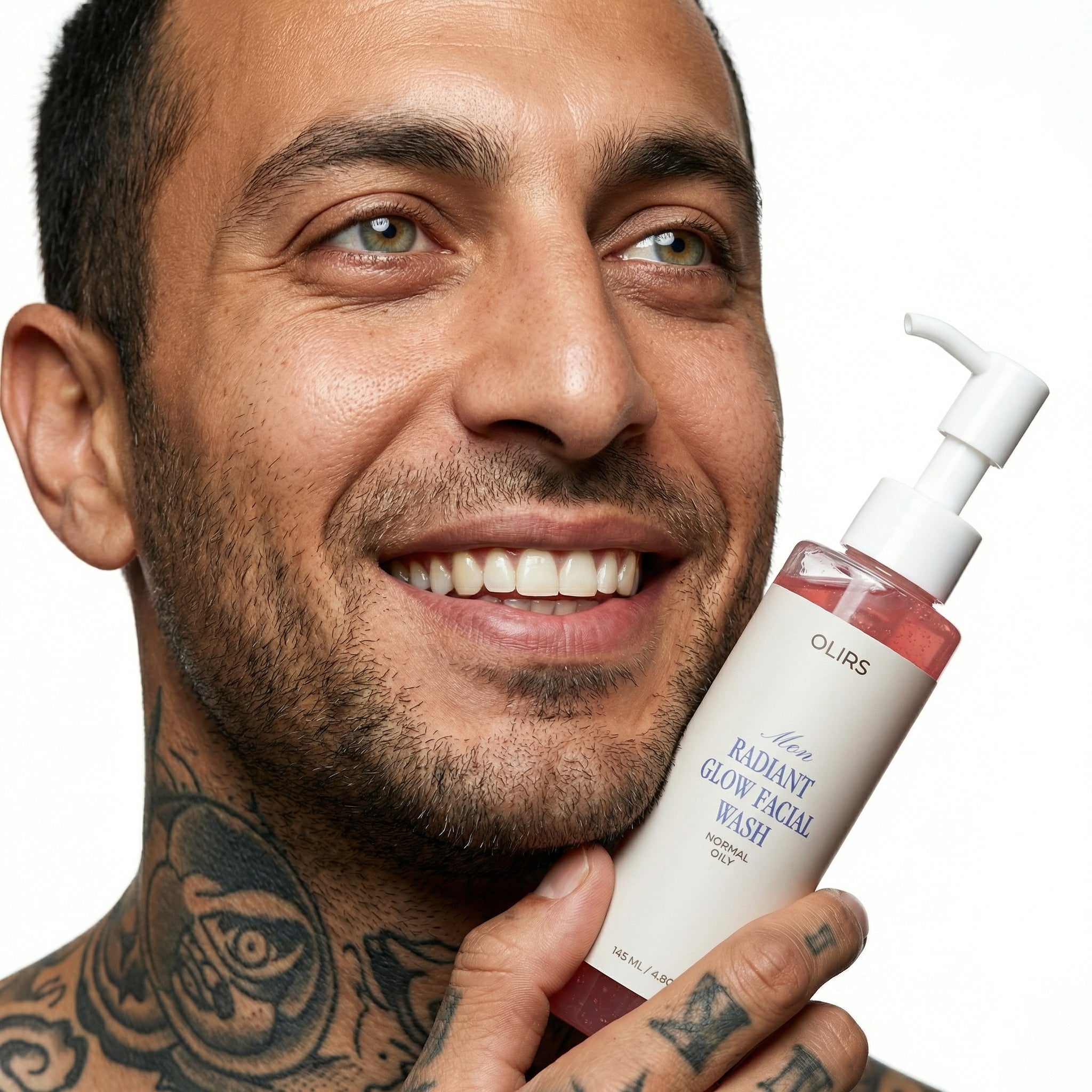 Man holding Radiant Glow Face Wash with a smile, showcasing its natural ingredients and fresh clean feel.