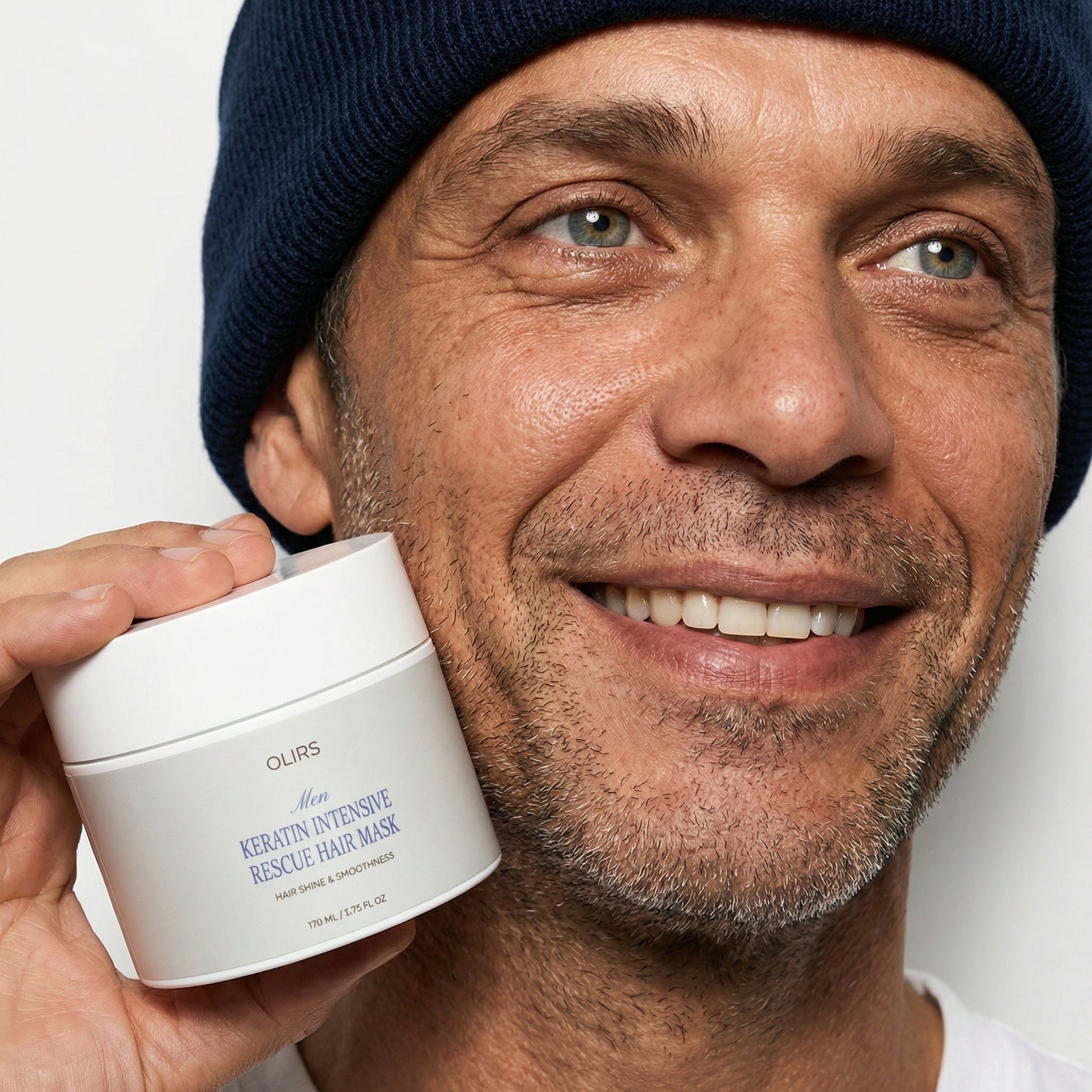 Smiling man holding Keratin Rescue Hair Mask, showcasing hair shine and smoothness benefits.