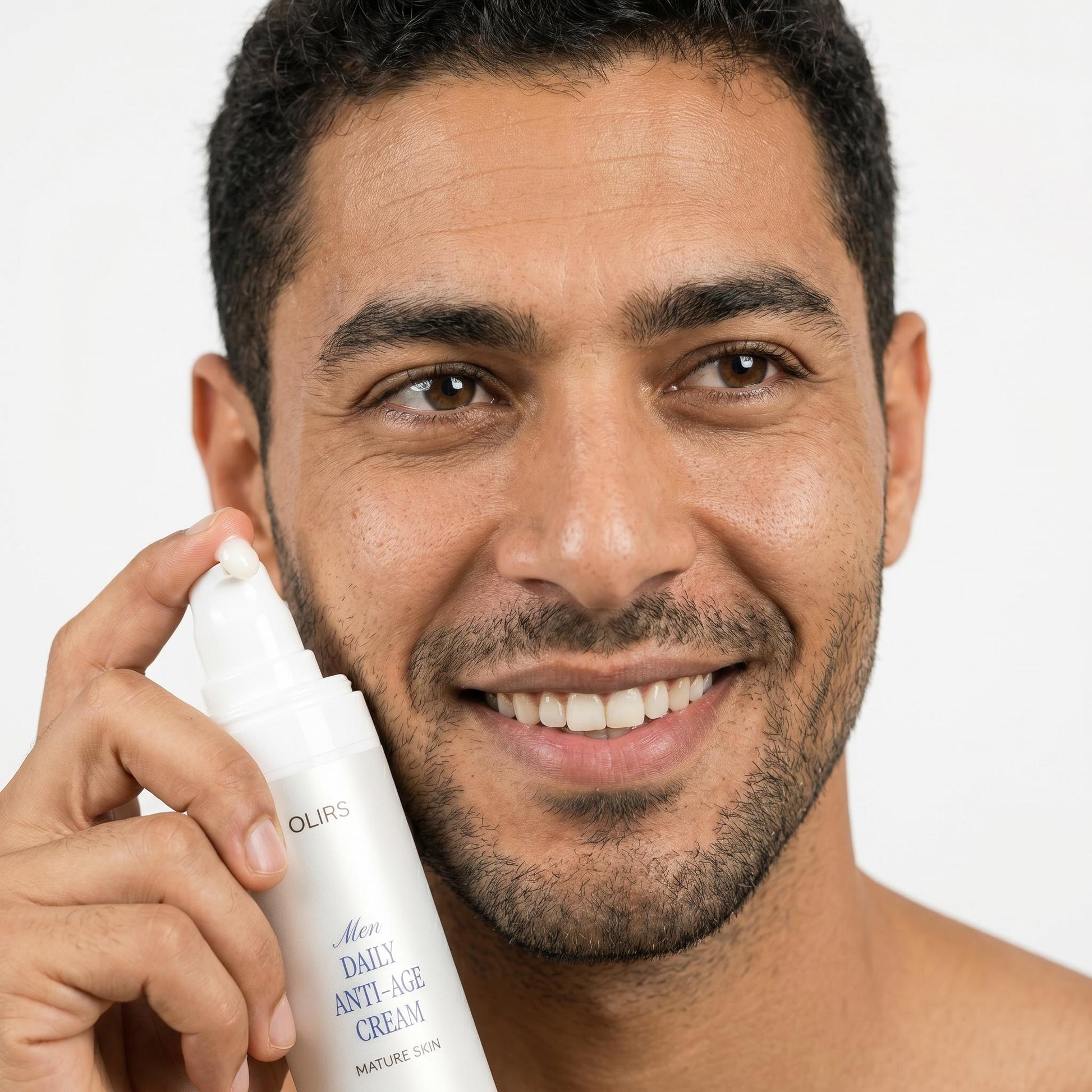 Man smiling while holding Men Daily Anti-Age Cream for mature skin, emphasizing skincare routine.
