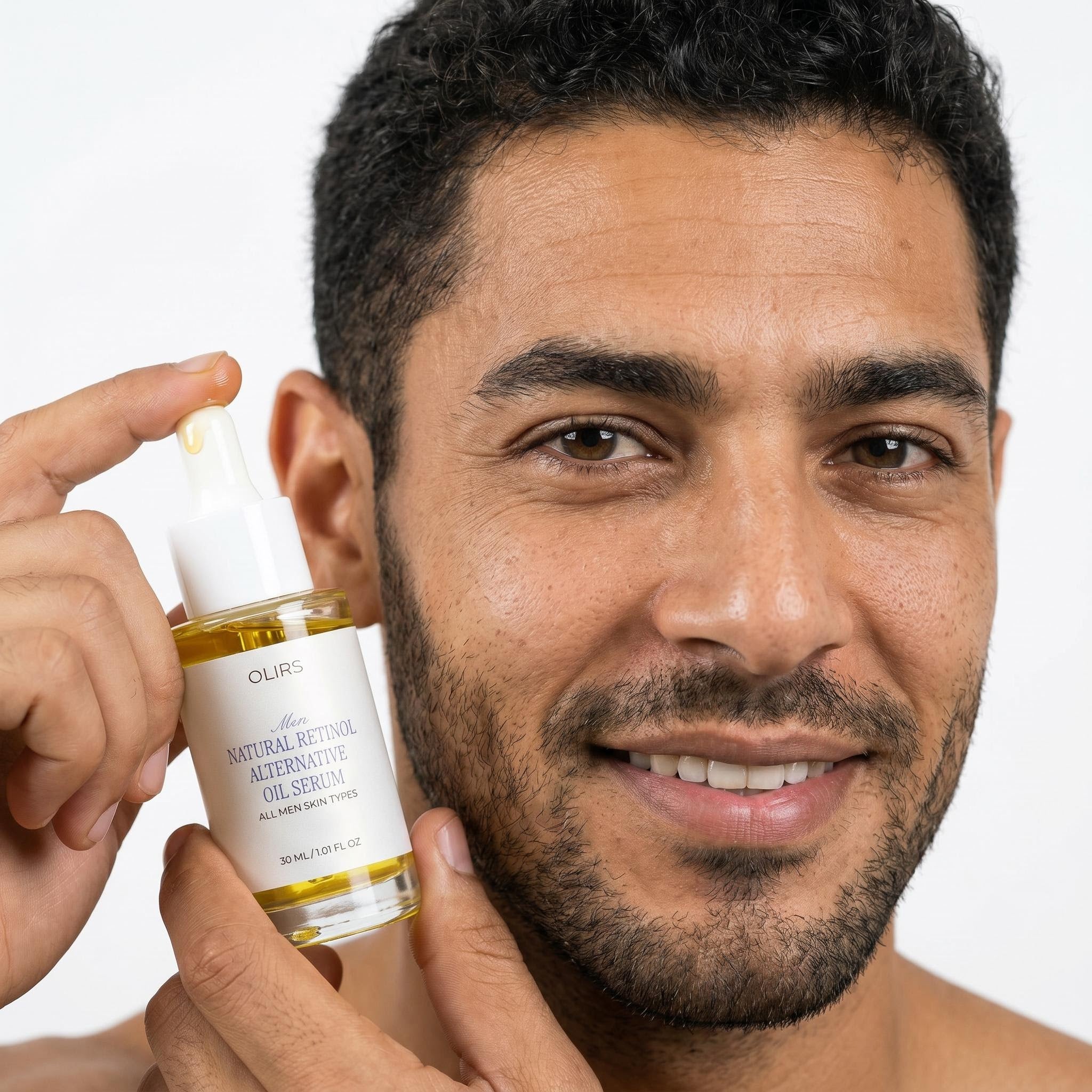 Man holding Bakuchiol Night Oil Serum with a bright smile, showcasing skincare routine for smoother-looking skin.