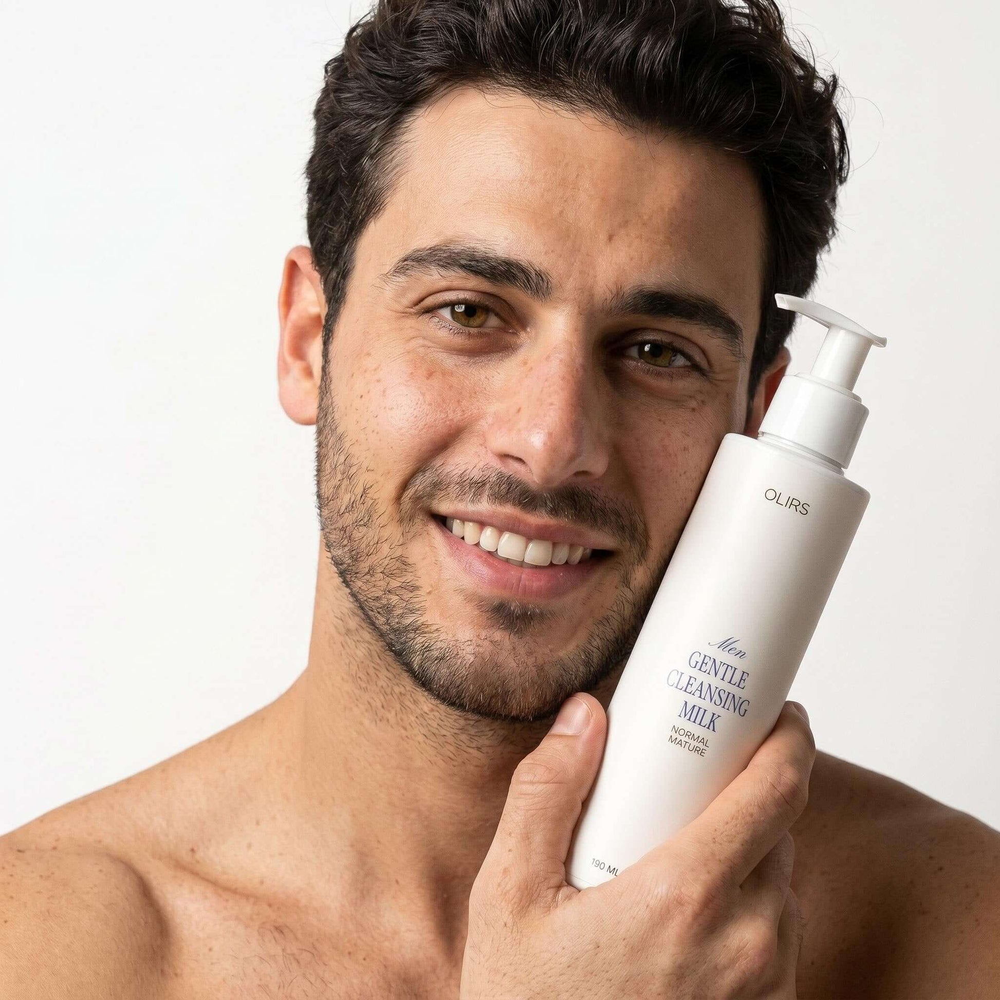 Man holding Gentle Cleansing Milk bottle, showcasing its creamy formula for sensitive skin.