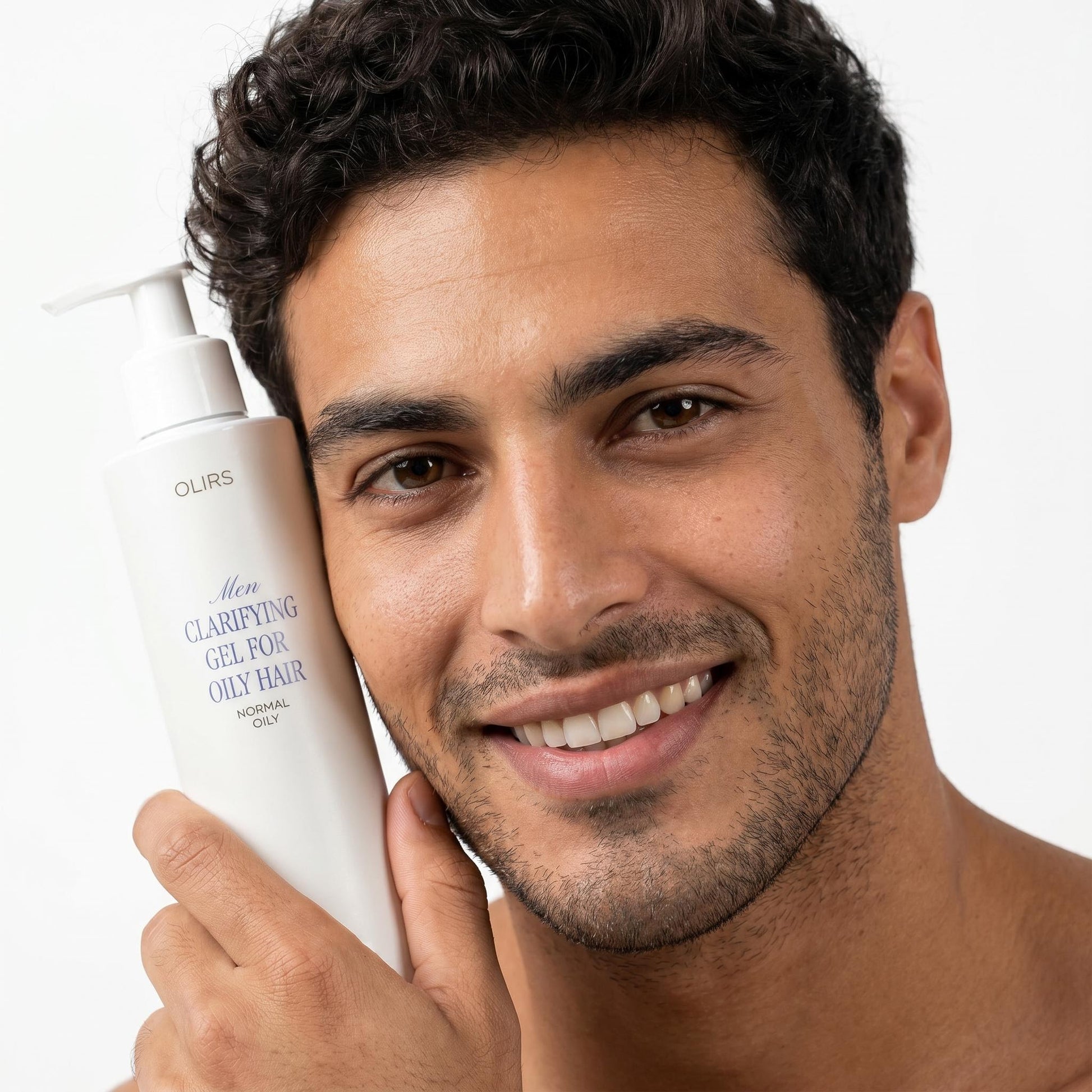 Man holding Daily Clarifying Gel Cleanser for oily hair, smiling and showcasing clean skin.