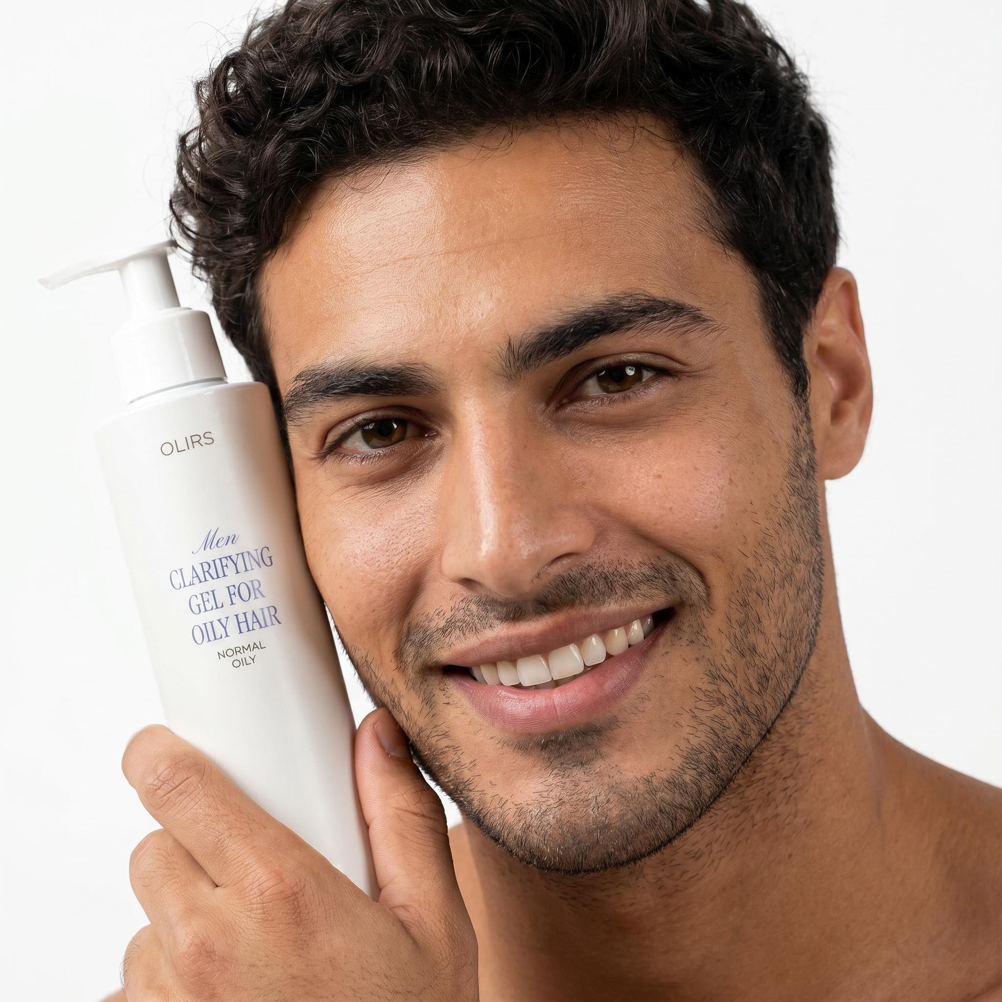 Man holding Daily Clarifying Gel Cleanser for oily hair, smiling and showcasing clean skin.