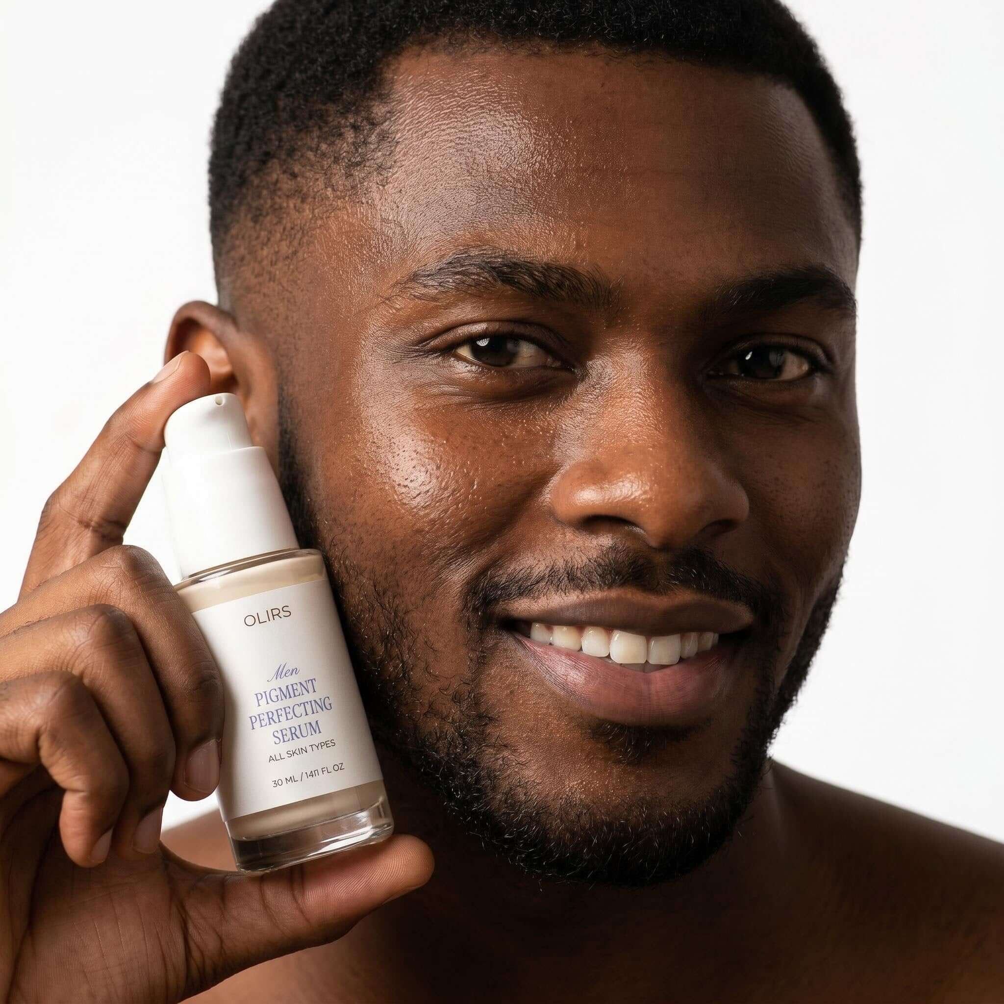 Even-Tone Glow Serum in hands of a man with smiling face showcasing bright and hydrated skin.