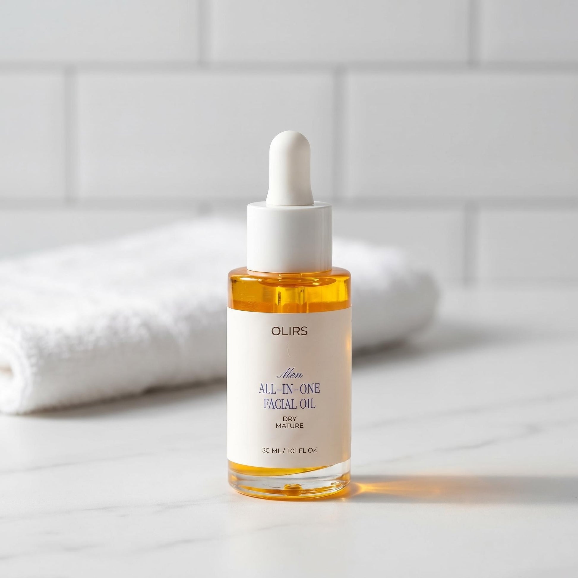 All-In-One Facial Oil bottle with dropper on marble countertop, ideal for dry and mature skin types.