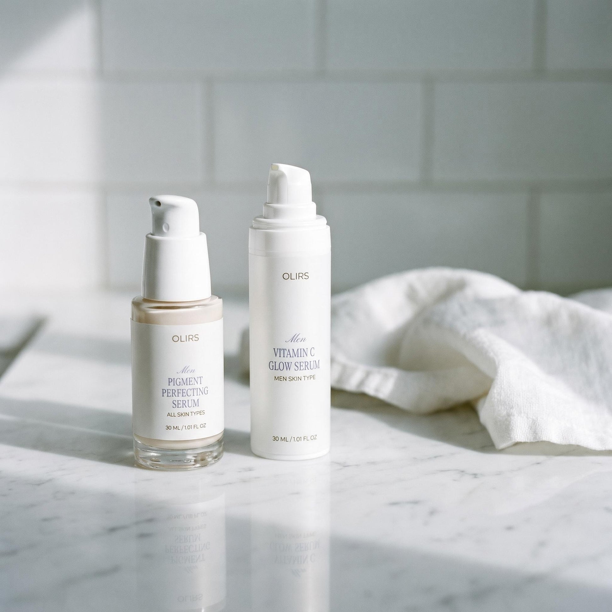 Even-Tone Routine Duo featuring Pigment Perfecting Serum and Vitamin C Glow Serum on a marble countertop.